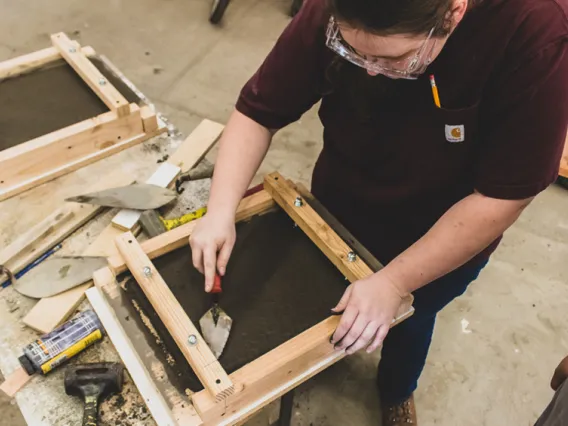 Student works on cement slab